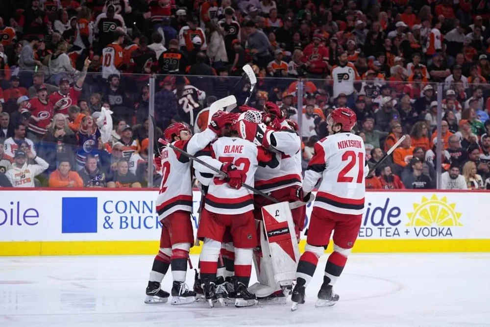 The Hurricanes celebrate after Jackson Blake's series-clinching goal in overtime of Game 4 against the Flyers.